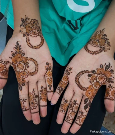 A close-up of a woman's hands adorned with intricate henna designs, showcasing easy Mehandi patterns.
