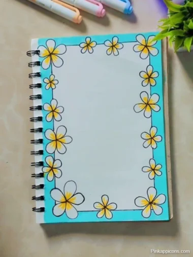 front page designs A notebook featuring floral designs on the front cover, accompanied by colorful pens placed on top.