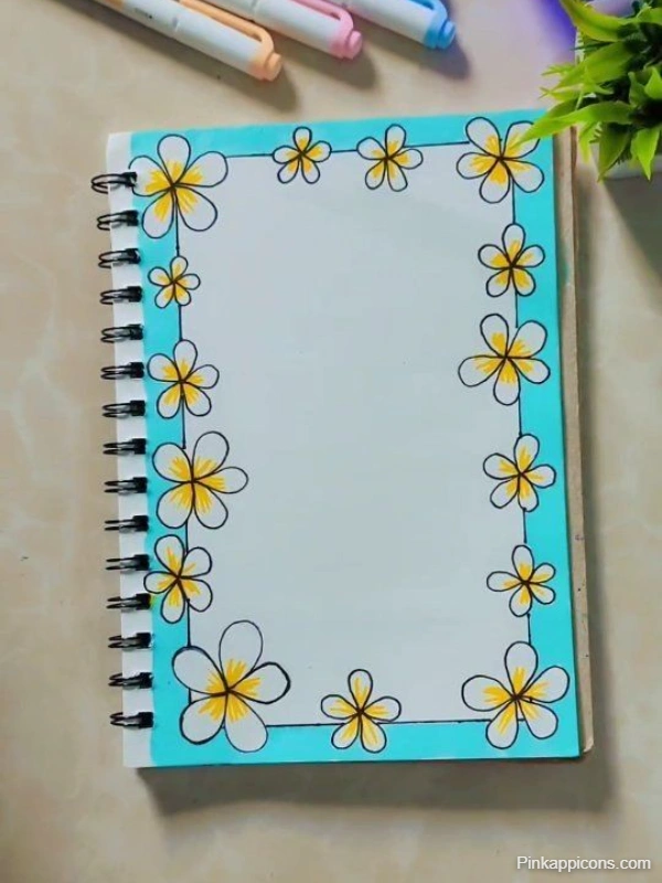 A notebook featuring floral designs on the front cover, accompanied by colorful pens placed on top.