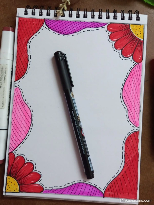 A handmade school project featuring a notebook with a pen and decorative flowers on the front page design.