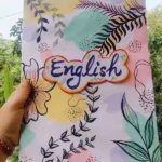 Front page design of a school English project notebook, featuring colorful graphics and a title prominently displayed.