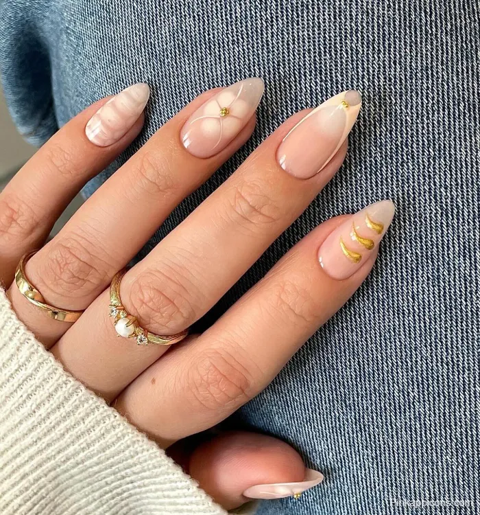 Almond Nails Elegant Nude Nail Art with White Marble, Flowers, and Gold Details