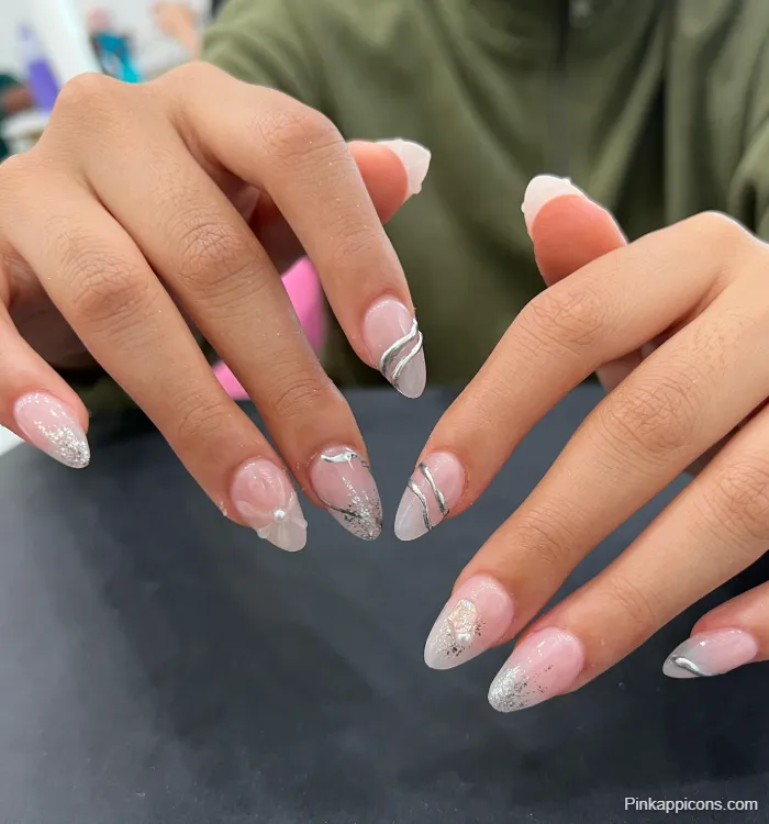 Almond Nails Silver Glitter Ombre French Tip with Silver Swirls and White Accents