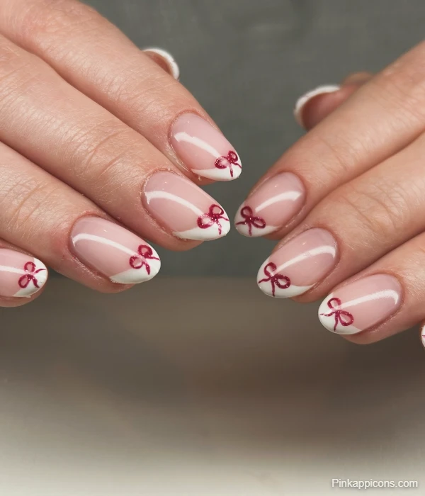 Elegant White French Tip Nails with Delicate Red Glitter Bows