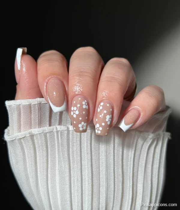 Elegant White French Tip Nails with Delicate White Flowers on Nude Base