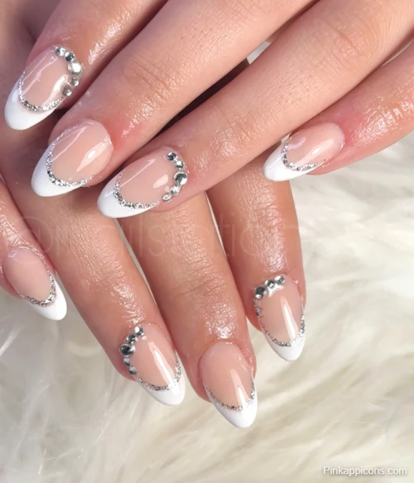 Elegant White French Tip Nails with Silver Glitter and Rhinestone Accents