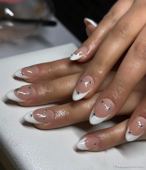 Elegant White French Tip Nails with Silver Star Accents and Rhinestones