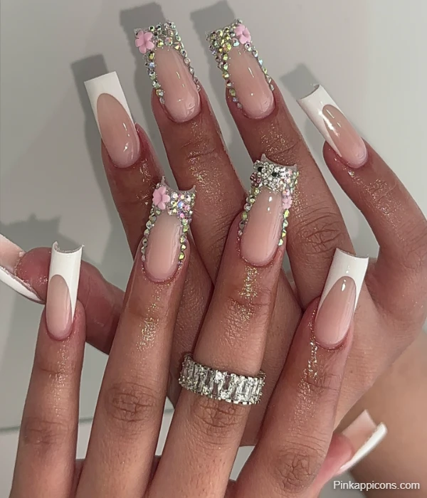 Glamorous White French Tip Nails with Rhinestones and Pink Flowers
