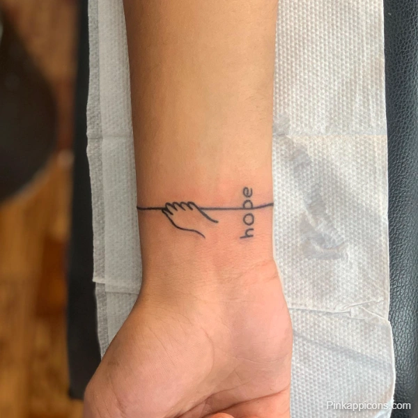 Small Hope and Hand Tattoo Idea Minimalist Wrist Design