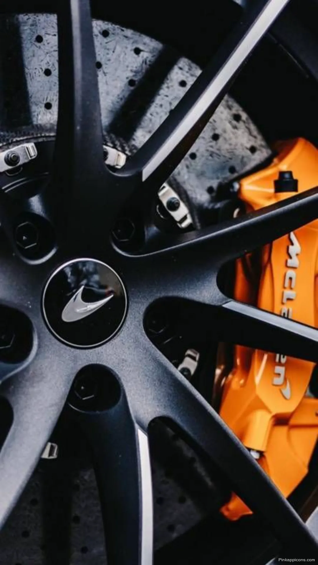 Detailed McLaren Wheel Wallpaper Iconic Logo and Orange Brake Caliper for Your Phone Background Detailed McLaren Wheel Wallpaper – Iconic Logo and Orange Brake Caliper for Your Phone Background