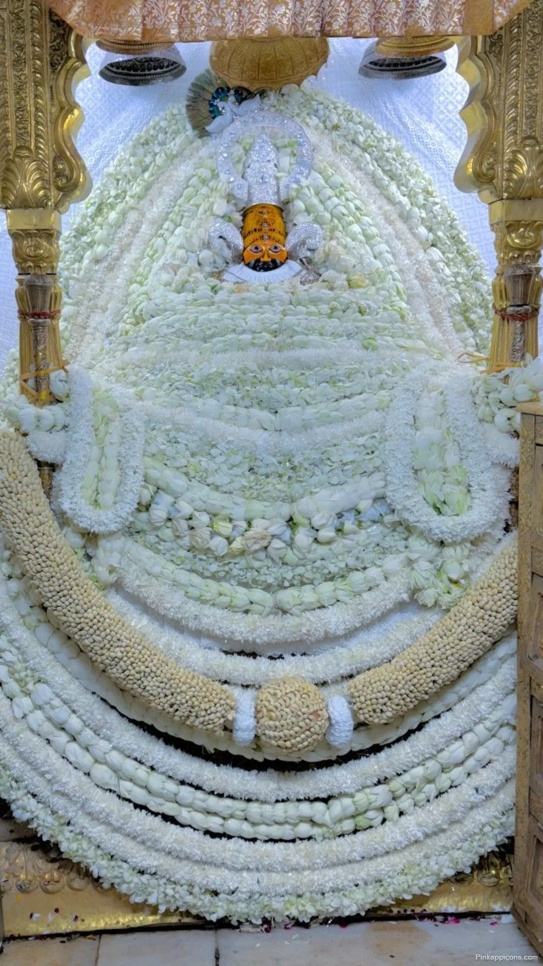 Divine Serenity White Flower Laden Khatushyam Ji Wallpaper Peaceful Ambiance for Your Mobile Screen Divine Serenity White Flower Laden Khatushyam Ji Wallpaper, Peaceful Ambiance for Your Mobile Screen