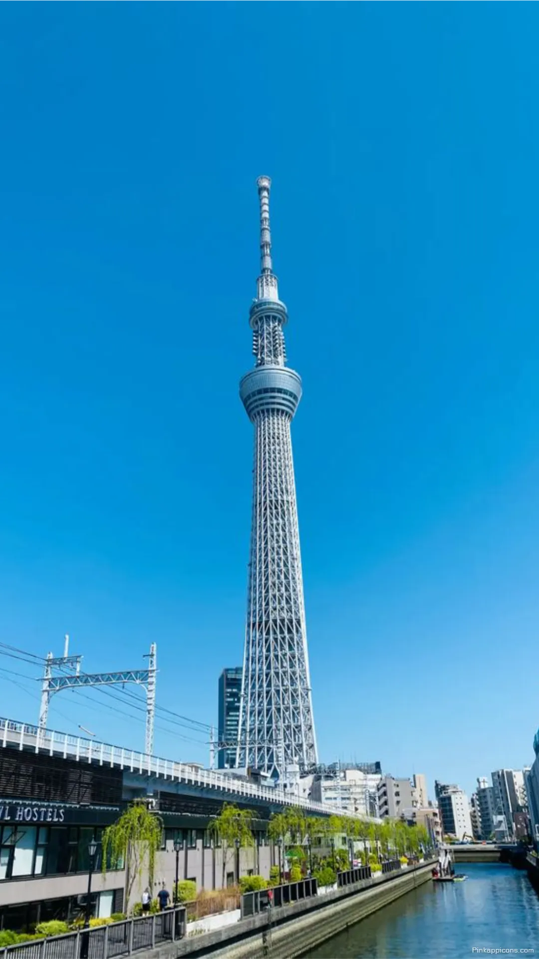 Iconic Tokyo Skytree overlooks the tranquil city river and vibrant buildings an breathtaking Tokyo wallpaper for your mobile device Iconic Tokyo Skytree overlooks the tranquil city river and vibrant buildings, an breathtaking Tokyo wallpaper for your mobile device