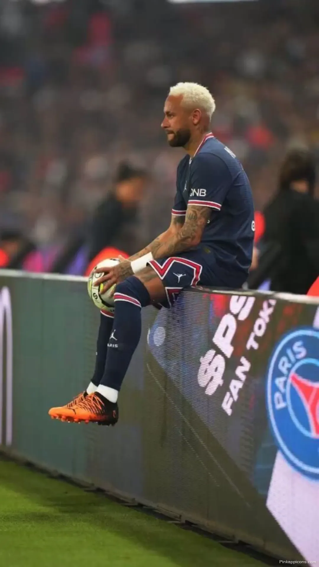 Neymar Wallpaper A focused shot of Neymar Jr. sitting on a barrier with a soccer ball great for your phone wallpaper Neymar Wallpaper A focused shot of Neymar Jr. sitting on a barrier with a soccer ball, great for your phone wallpaper.