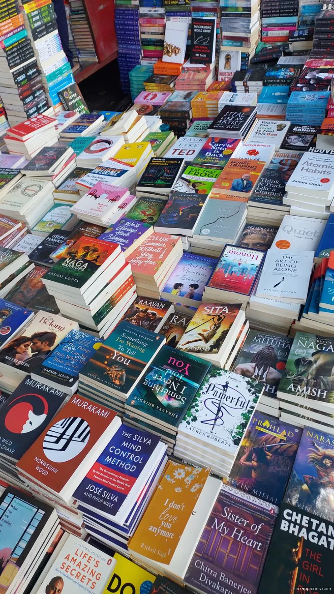 A readers paradise book wallpaper showing a vibrant outdoor book stall for your phone A reader’s paradise book wallpaper showing a vibrant outdoor book stall for your phone.