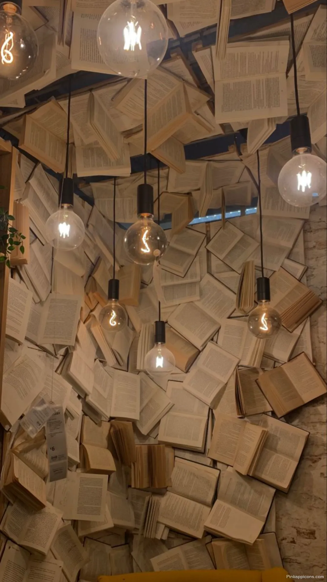 Creative book wallpaper featuring a unique art installation of open books and Edison bulbs Creative book wallpaper featuring a unique art installation of open books and Edison bulbs.