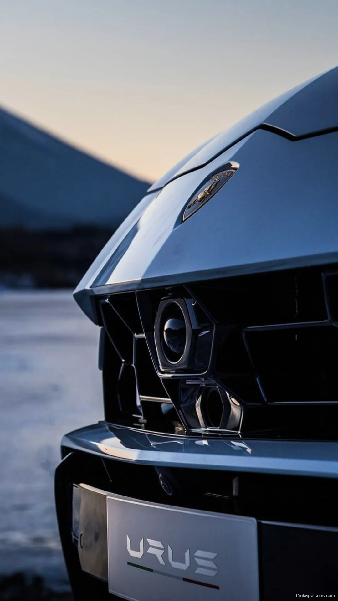 Luxury SUV Lamborghini Urus Wallpaper Prominent Grille and Badge Detail in a Scenic Landscape for Phones Luxury SUV Lamborghini Urus Wallpaper Prominent Grille and Badge Detail in a Scenic Landscape for Phones